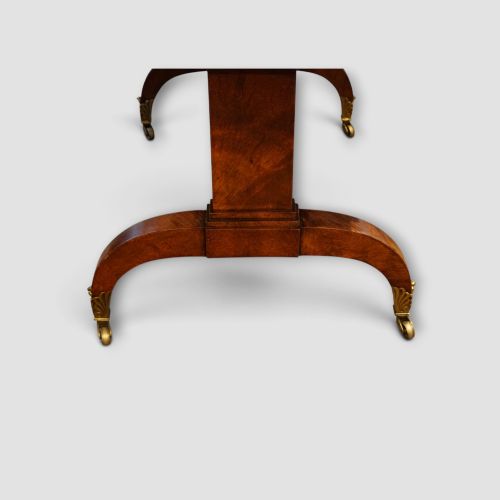 fig 5. A Regency burr satinwood sofa table with drop leaves, two frieze drawers, brass handles, and splayed legs on castors.
