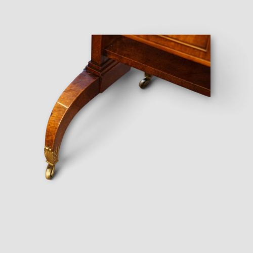 fig 8. A Regency burr satinwood sofa table with drop leaves, two frieze drawers, brass handles, and splayed legs on castors.