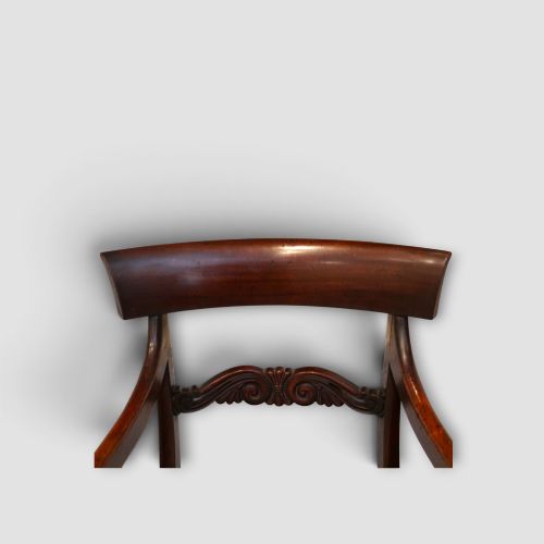 fig 1. A set of eight William IV dark mahogany dining chairs comprising six side chairs and two carvers with turned front legs and light neutral upholstered seats.