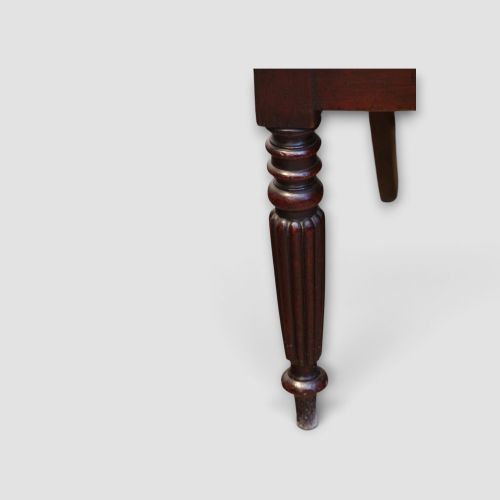 fig 3. A set of eight William IV dark mahogany dining chairs comprising six side chairs and two carvers with turned front legs and light neutral upholstered seats.