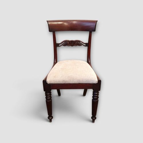 fig 6. A set of eight William IV dark mahogany dining chairs comprising six side chairs and two carvers with turned front legs and light neutral upholstered seats.