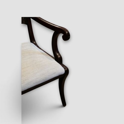 fig 2. A set of eight Regency mahogany dining chairs with neutral cream upholstery, carved back rails, and curved sabre legs.