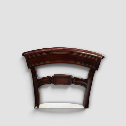 fig 5. A set of eight Regency mahogany dining chairs with neutral cream upholstery, carved back rails, and curved sabre legs.