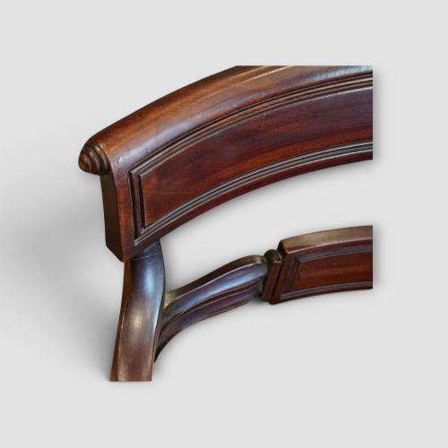 fig 6. A set of eight Regency mahogany dining chairs with neutral cream upholstery, carved back rails, and curved sabre legs.