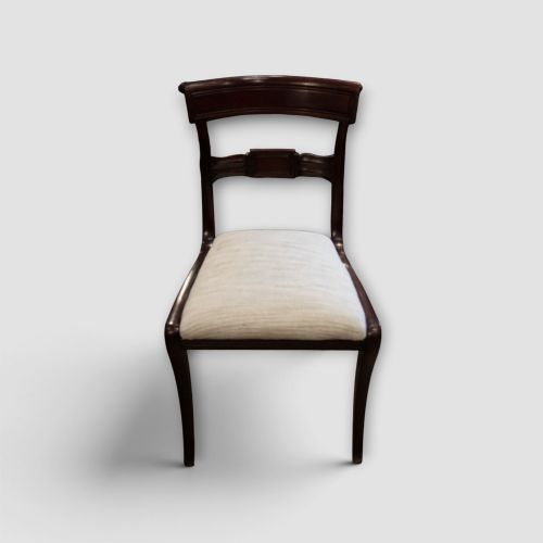 fig 8. A set of eight Regency mahogany dining chairs with neutral cream upholstery, carved back rails, and curved sabre legs.
