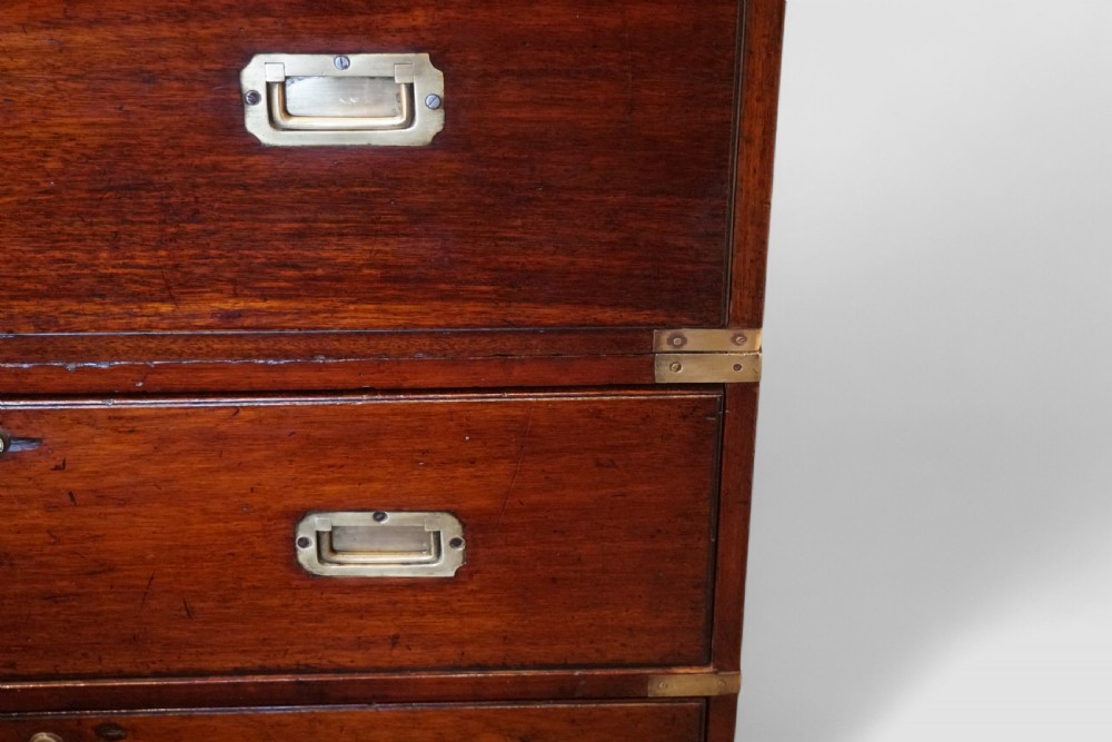 A two-part Victorian mahogany campaign chest featuring flush brass corner brackets, inset handles, and turned feet. View XI