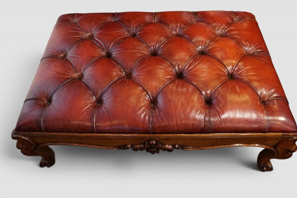 A large Victorian walnut stool featuring deep-buttoned russet red leather upholstery and carved cabriole legs. View III