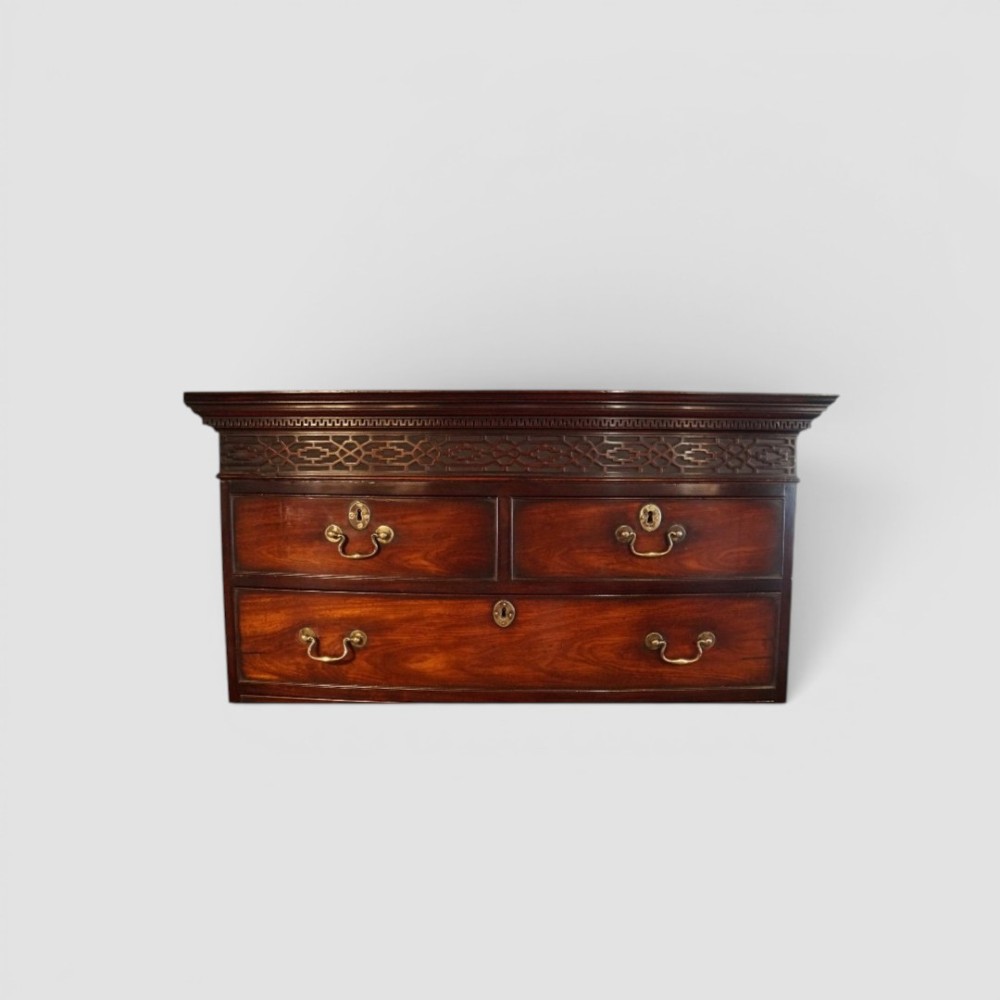 A tall George III mahogany chest-on-chest featuring a carved blind fretwork cornice, brass swan-neck handles, and bracket feet. View IV