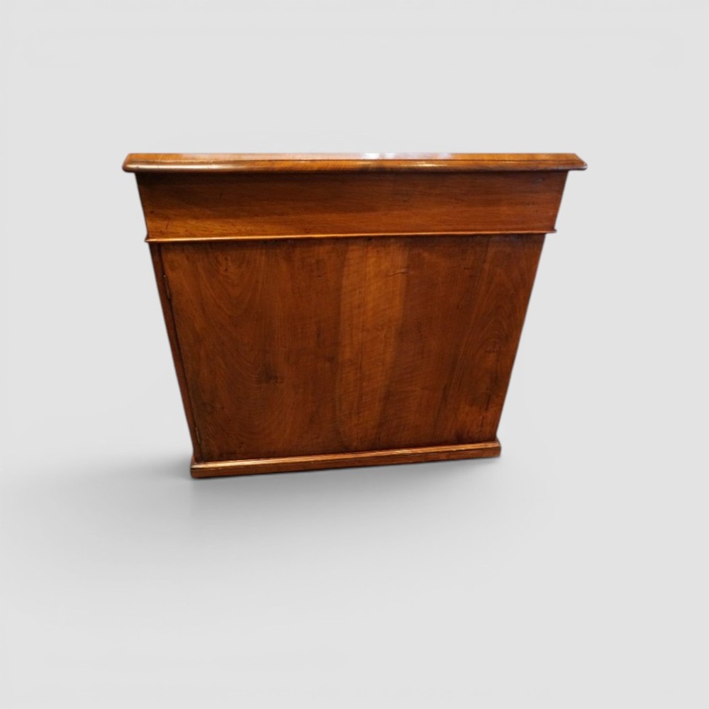 A Victorian mahogany partners desk featuring a tooled leather writing surface, twin pedestals, and an eleven-drawer front configuration with turned wooden knobs. View V