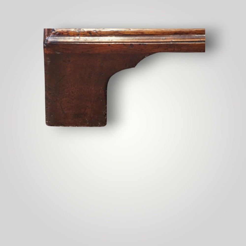 A George III mahogany bachelors chest featuring a top brushing slide, graduated drawers with pierced brass handles, and bracket feet. View III
