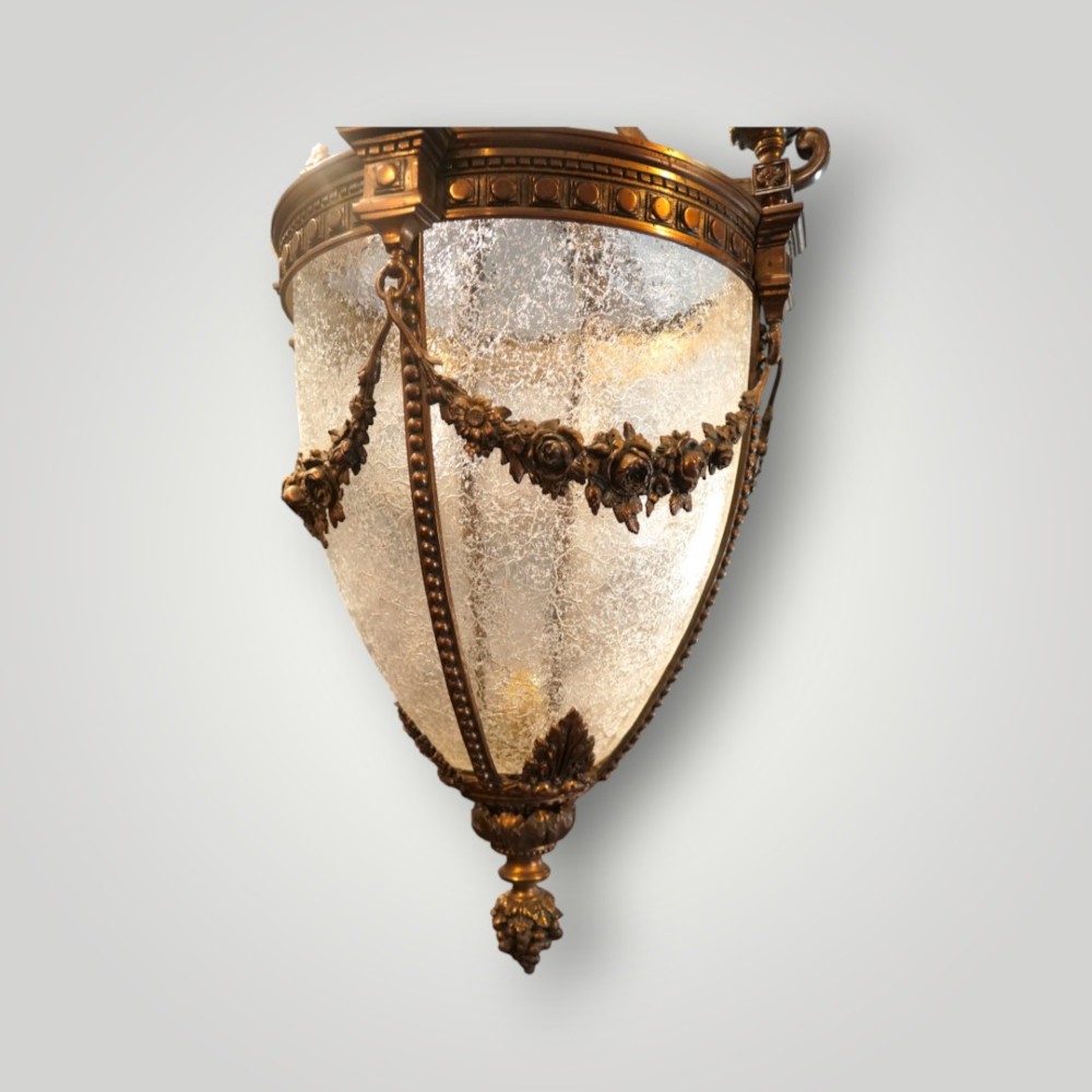 A nineteenth-century gilt bronze hall lantern featuring a tapered glass vessel, acanthus leaf canopy, and decorative drapery swags. View VII