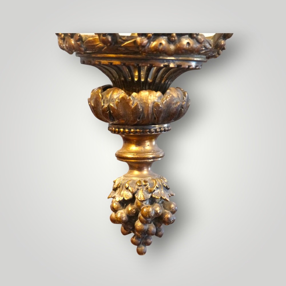 A nineteenth-century gilt bronze hall lantern featuring a tapered glass vessel, acanthus leaf canopy, and decorative drapery swags. View X
