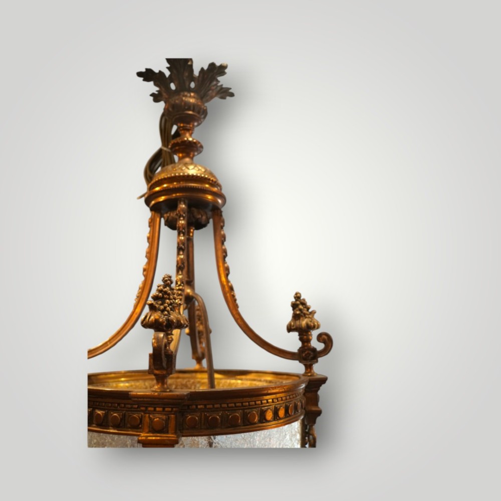 A nineteenth-century gilt bronze hall lantern featuring a tapered glass vessel, acanthus leaf canopy, and decorative drapery swags. View XIII
