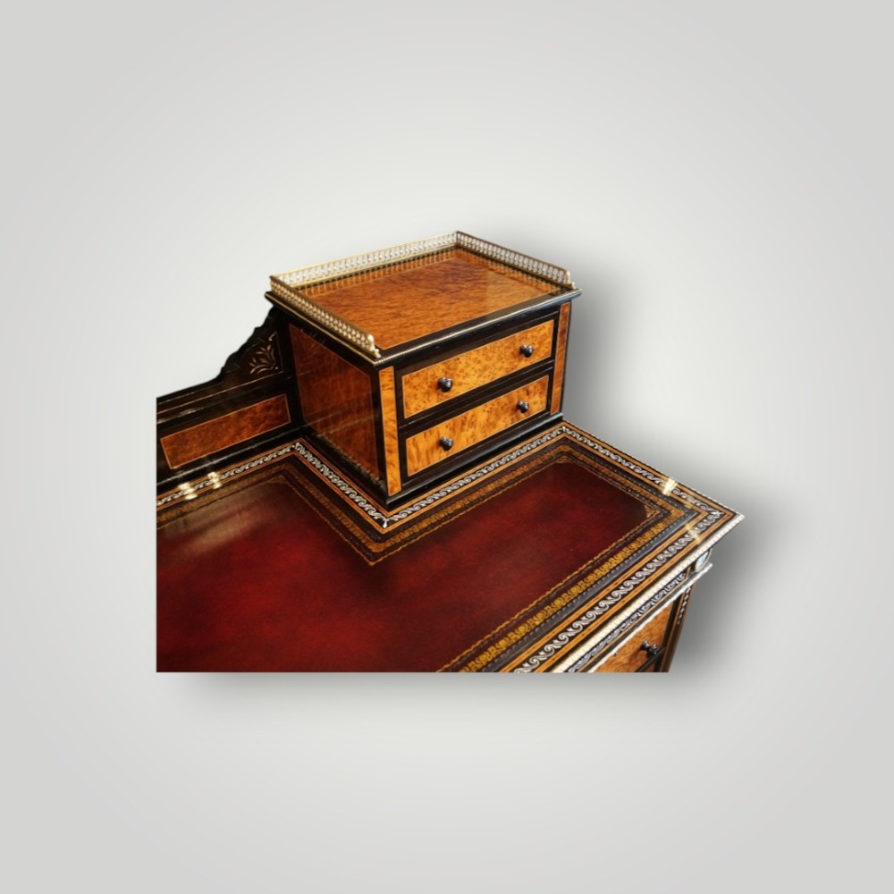 A Victorian ebonised and thuya wood pedestal desk featuring a leather writing surface, raised side drawers, ivory inlay, and ceramic plaque details. View II