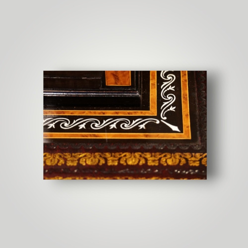A Victorian ebonised and thuya wood pedestal desk featuring a leather writing surface, raised side drawers, ivory inlay, and ceramic plaque details. View VII
