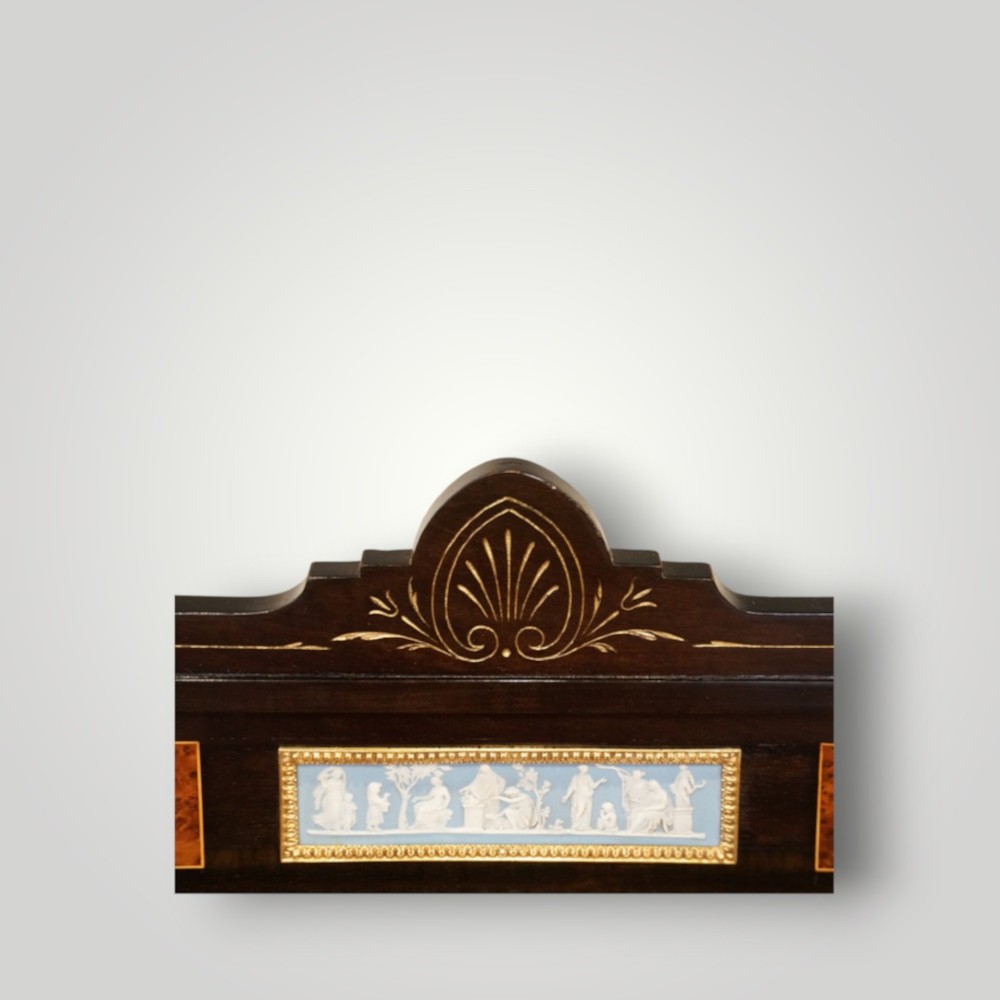 A Victorian ebonised and thuya wood pedestal desk featuring a leather writing surface, raised side drawers, ivory inlay, and ceramic plaque details. View XI