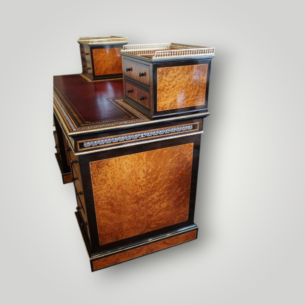 A Victorian ebonised and thuya wood pedestal desk featuring a leather writing surface, raised side drawers, ivory inlay, and ceramic plaque details. View XIV