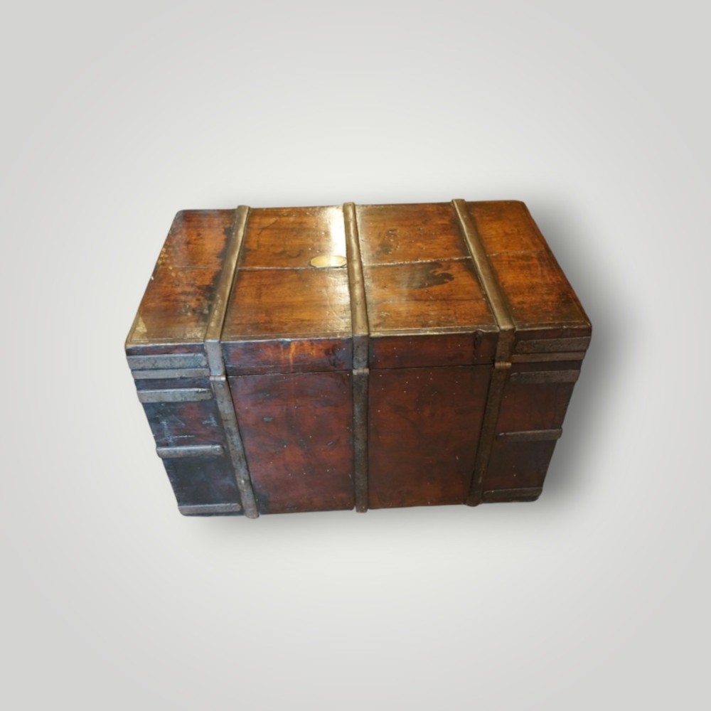 A rectangular antique walnut wood trunk featuring heavy iron binding straps, metal corner hardware, and a brass plaque on the lid. View IX