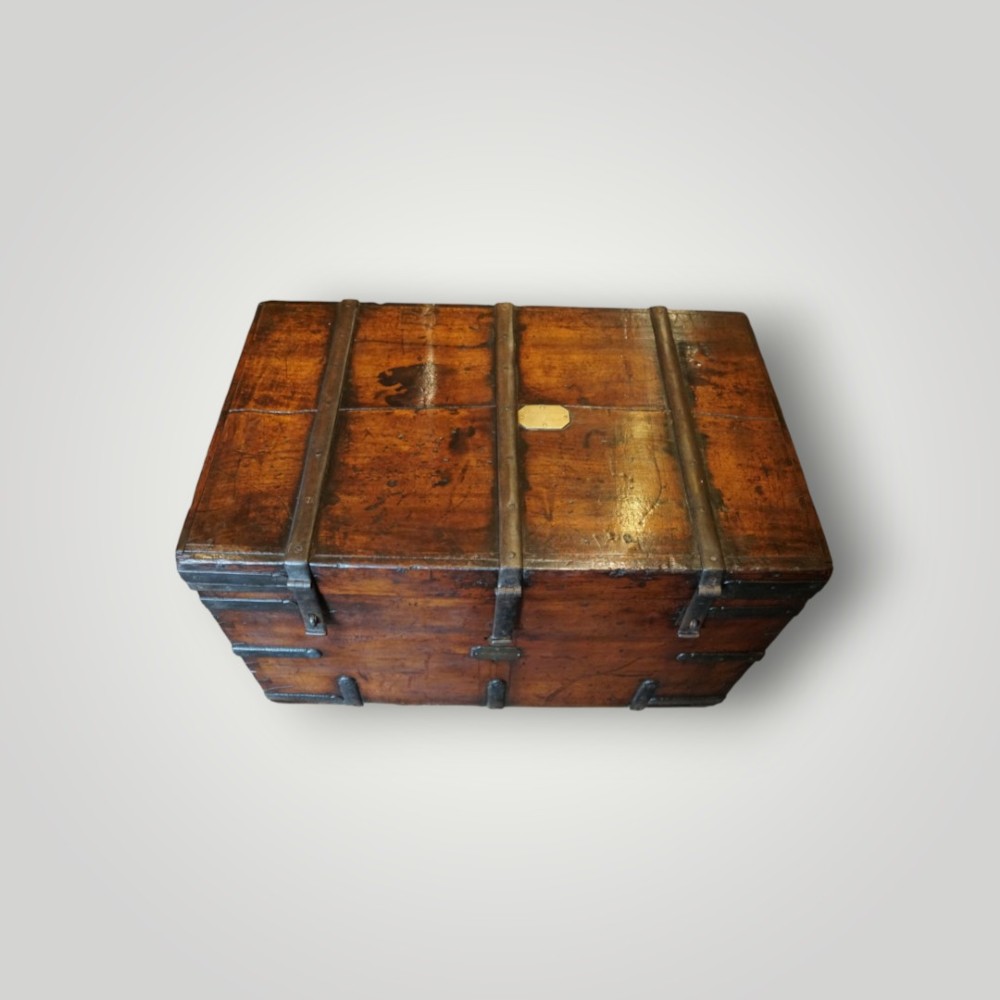 A rectangular antique walnut wood trunk featuring heavy iron binding straps, metal corner hardware, and a brass plaque on the lid. View XI