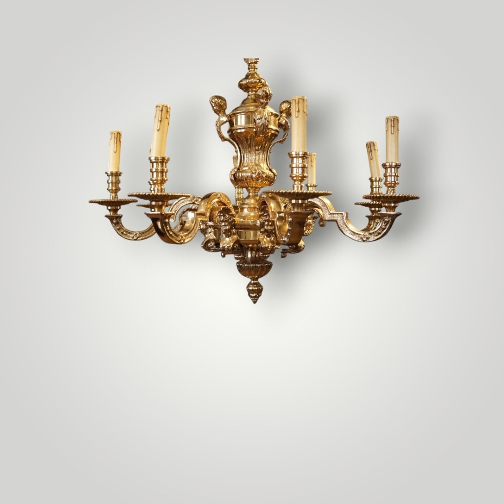 A nineteenth-century French gilt bronze eight-light chandelier featuring a central urn column and scrolling candle arms with faux candle sleeves. View VI