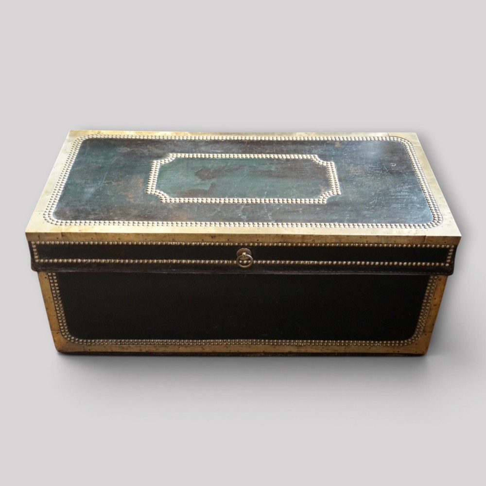 An antique dark green leather trunk featuring brass corner straps, close-studded brass borders, and a brass keyhole escutcheon. View III