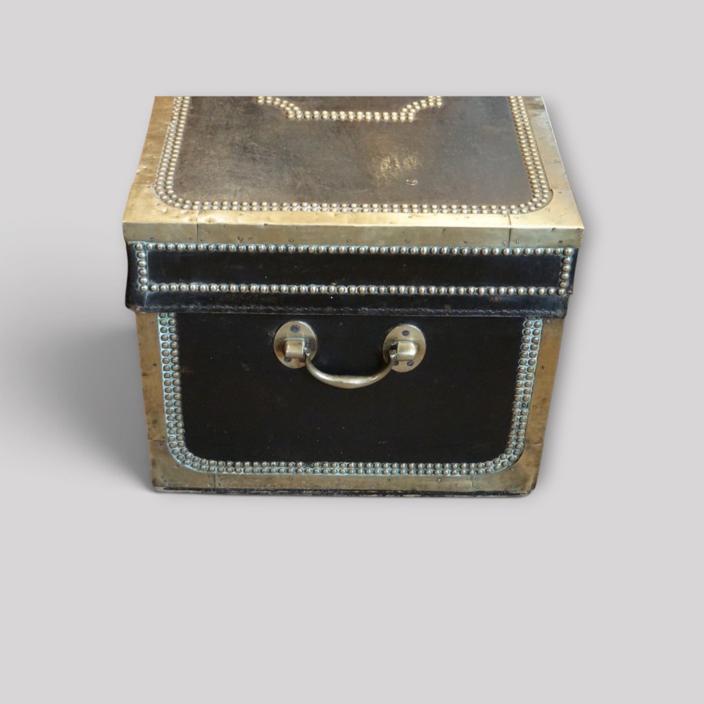 An antique dark green leather trunk featuring brass corner straps, close-studded brass borders, and a brass keyhole escutcheon. View VIII