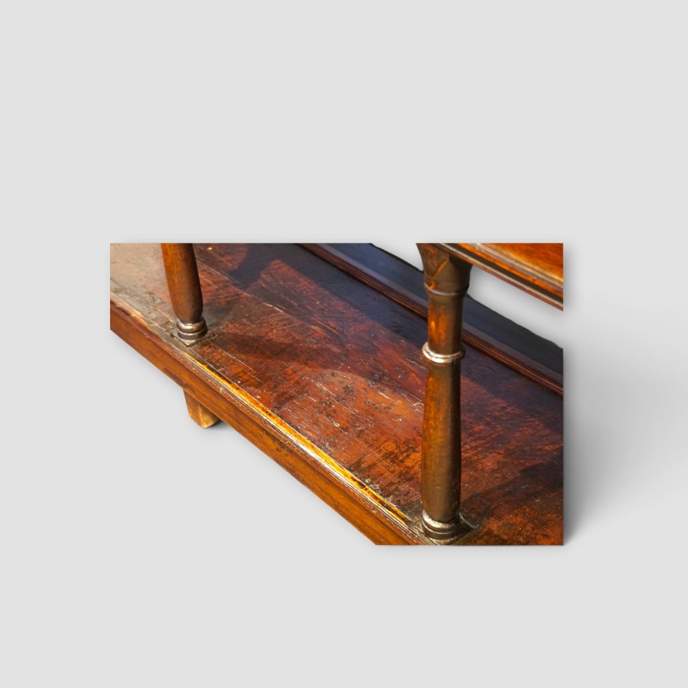 An antique dark oak dresser base featuring three frieze drawers with brass handles supported by turned legs and a low open potboard shelf. View II