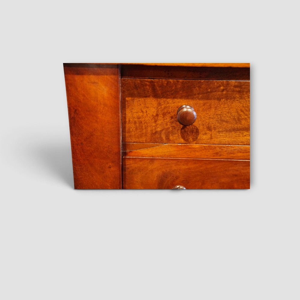 A tall Victorian mahogany Wellington chest featuring seven drawer fronts, turned wooden knobs, and a right-hand side locking flap. View IX