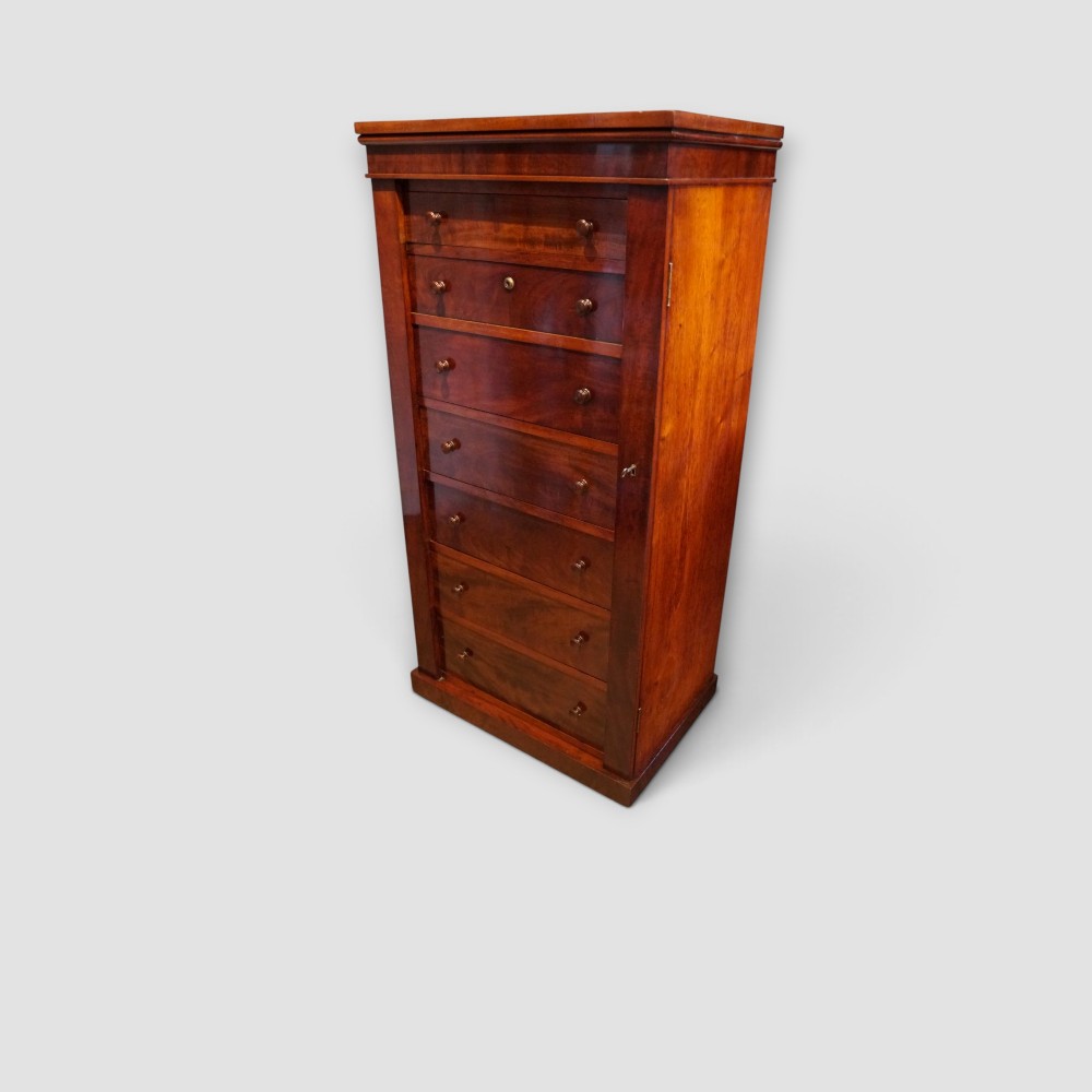 A tall Victorian mahogany Wellington chest featuring seven drawer fronts, turned wooden knobs, and a right-hand side locking flap. View XI