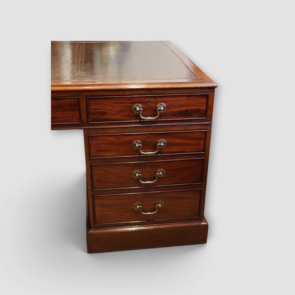 A large Victorian mahogany partners desk featuring a brown leather inset writing surface, twin drawer pedestals, brass swan-neck handles, and a wide central kneehole. View III