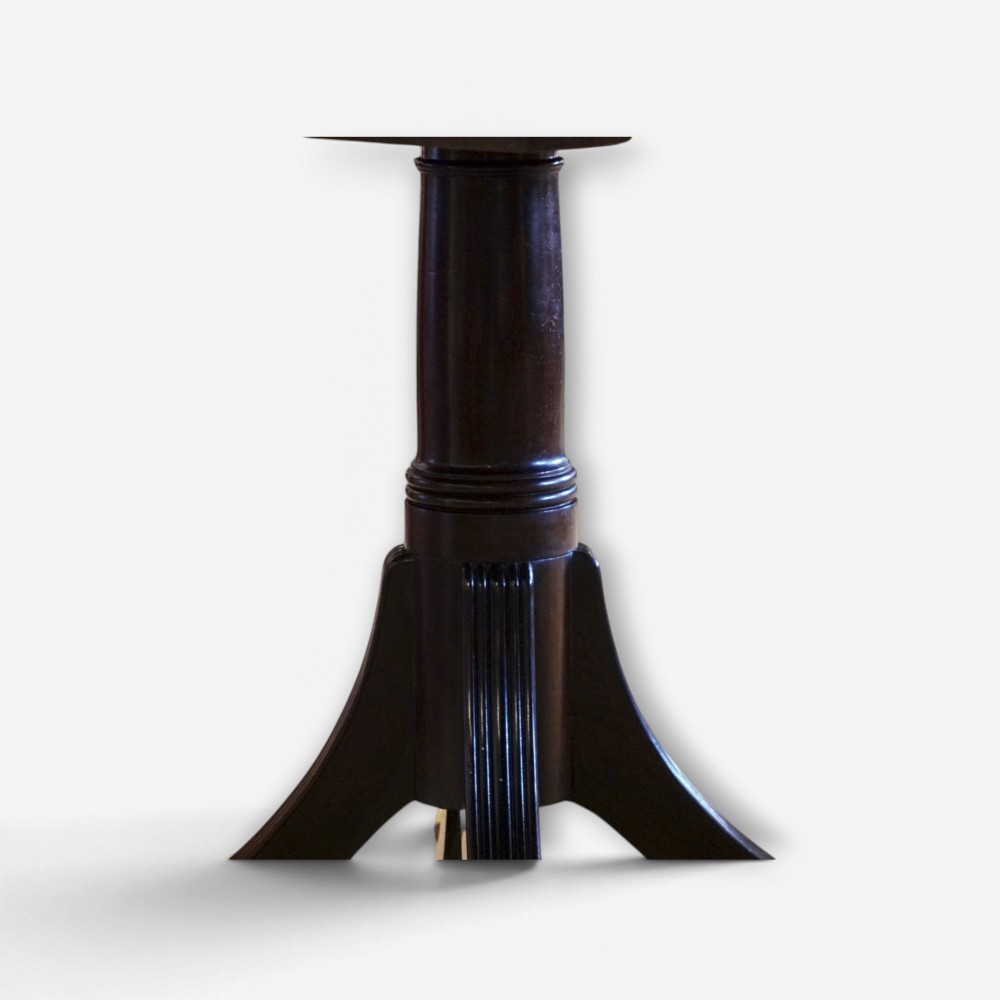 A Georgian style dark mahogany dining table featuring an extendable top, twin turned pedestal pillars, and splayed quadruped legs with brass toe caps. View XII