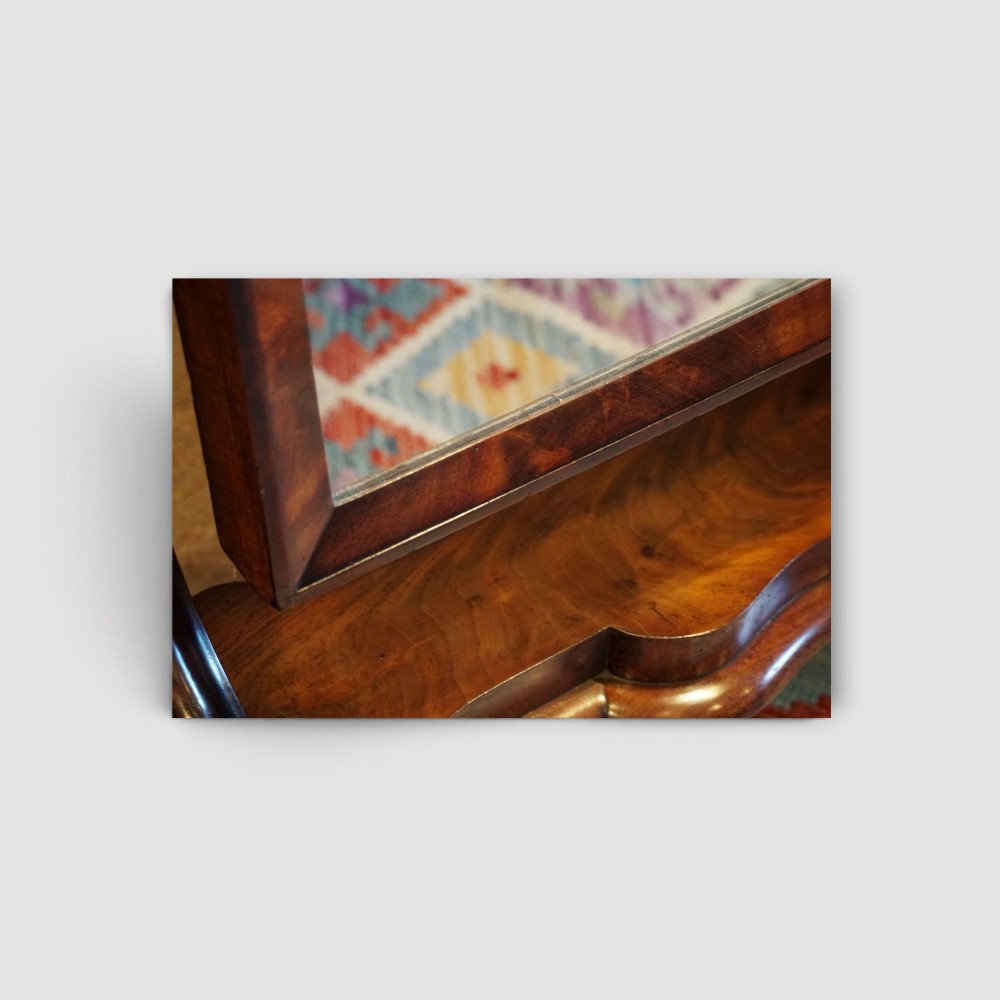 A Victorian mahogany cheval mirror with a rectangular rounded tilting glass frame, dual upright supports, and a curved plinth base set on scroll legs. View VII