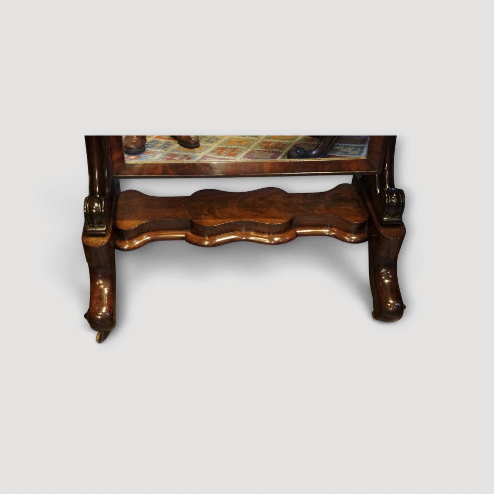 A Victorian mahogany cheval mirror with a rectangular rounded tilting glass frame, dual upright supports, and a curved plinth base set on scroll legs. View IX