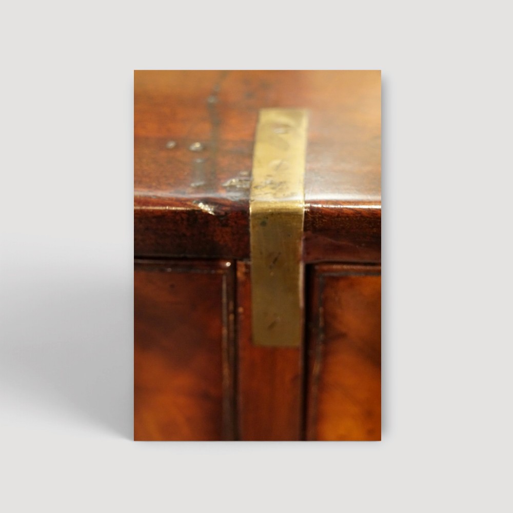A Victorian mahogany campaign chest featuring two short drawers over three long drawers with flush brass handles, brass corner brackets, and turned feet. View II