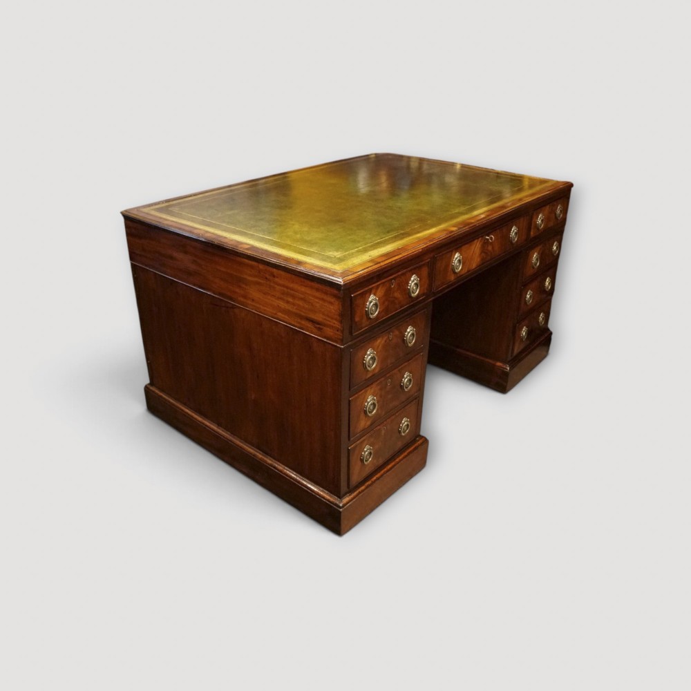 A Victorian mahogany partners desk featuring a green leather writing surface, dual pedestals with drawers, and round brass handles. View II