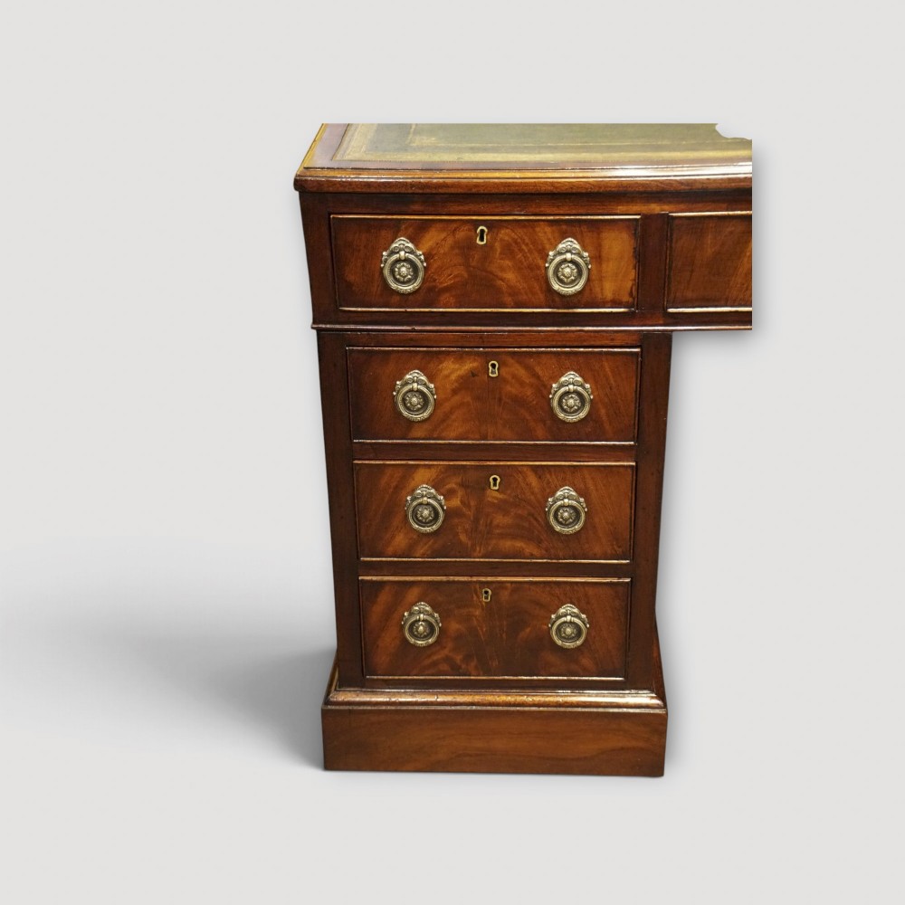 A Victorian mahogany partners desk featuring a green leather writing surface, dual pedestals with drawers, and round brass handles. View VI