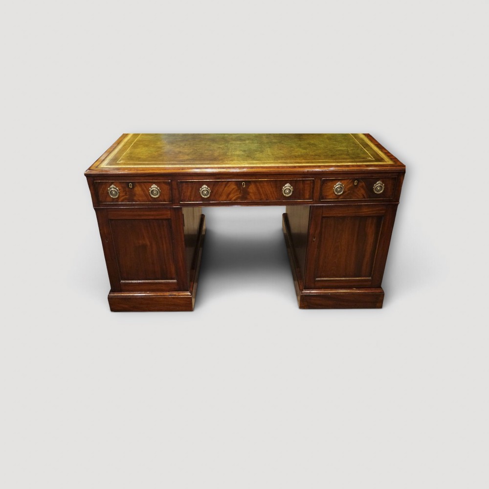 A Victorian mahogany partners desk featuring a green leather writing surface, dual pedestals with drawers, and round brass handles. View IX