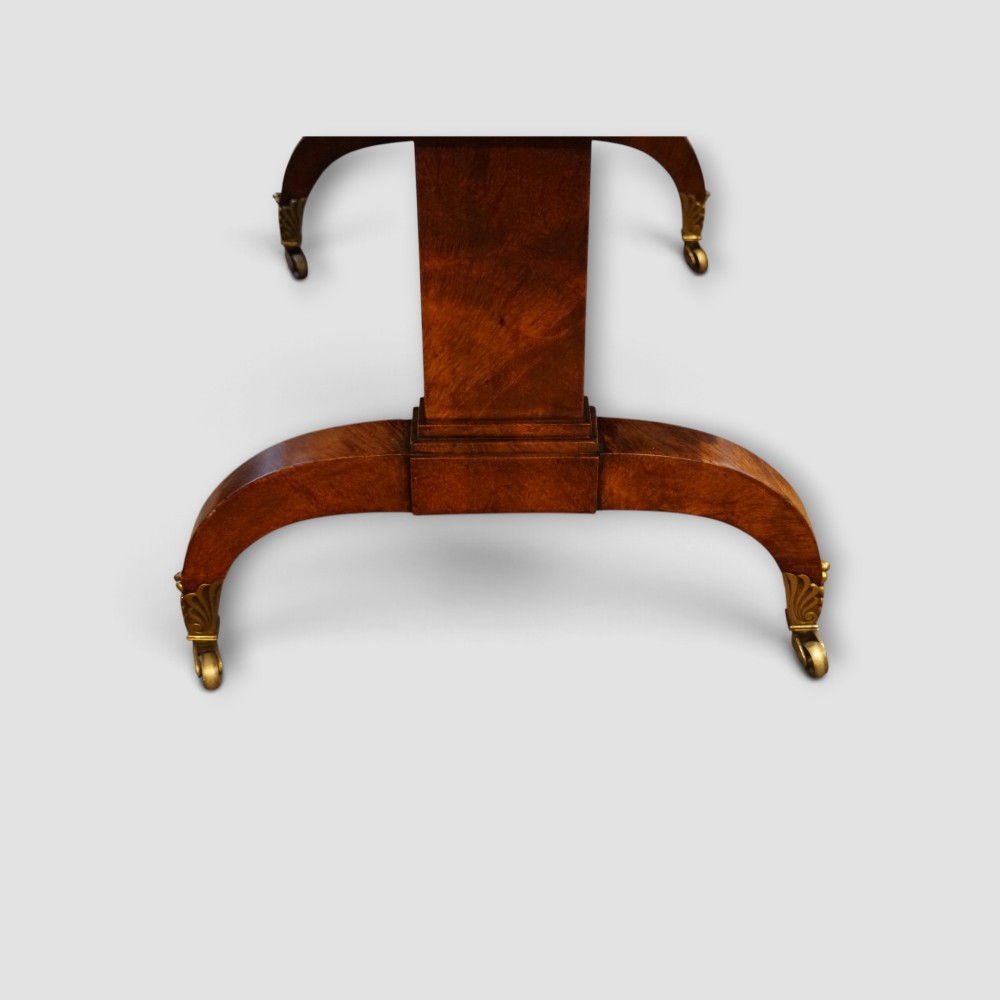 A Regency burr satinwood sofa table with drop leaves, two frieze drawers, brass handles, and splayed legs on castors. View VI