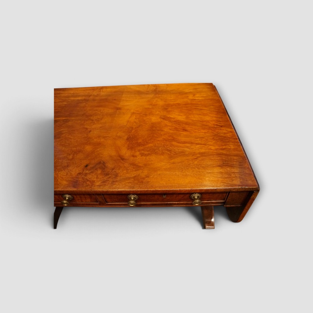 A Regency burr satinwood sofa table with drop leaves, two frieze drawers, brass handles, and splayed legs on castors. View XII