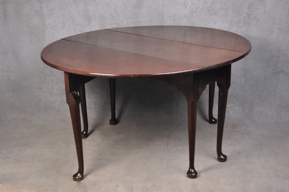 An 18th-century mahogany gateleg table featuring a drop-leaf top, hinged rounded leaves, and slender cabriole legs terminating in pad feet. View II