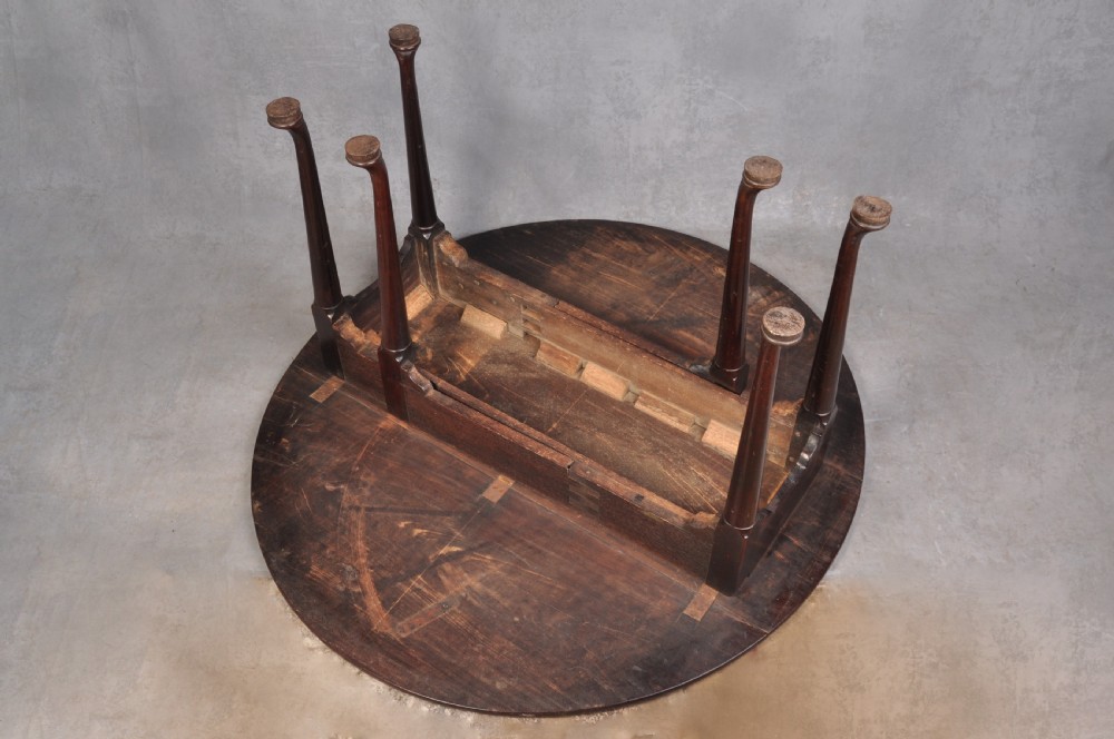 An 18th-century mahogany gateleg table featuring a drop-leaf top, hinged rounded leaves, and slender cabriole legs terminating in pad feet. View IV