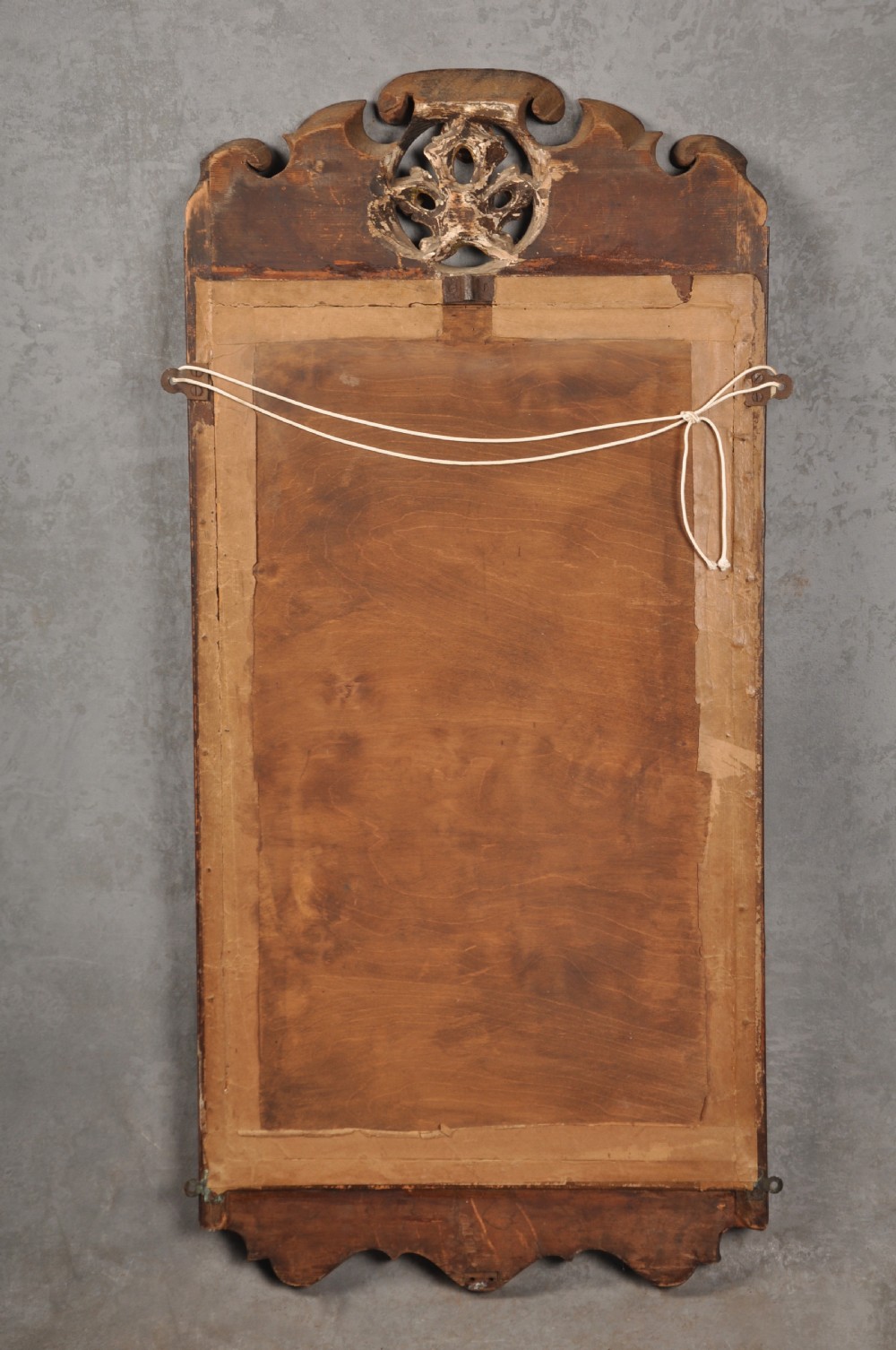 An early 18th-century walnut wall mirror featuring shaped scroll cresting with a carved giltwood shell motif and a gilded inner slip surrounding a rectangular mirror glass. View V