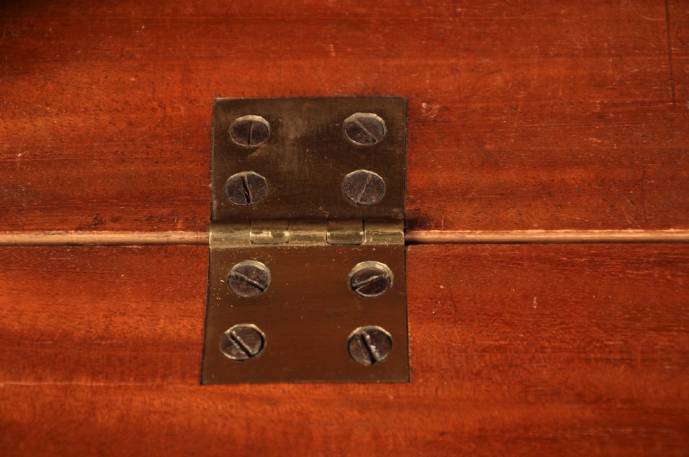 An 18th-century Georgian flame mahogany tallboy featuring a carved fretwork cornice, brass swan-neck handles, and ogee bracket feet. View X