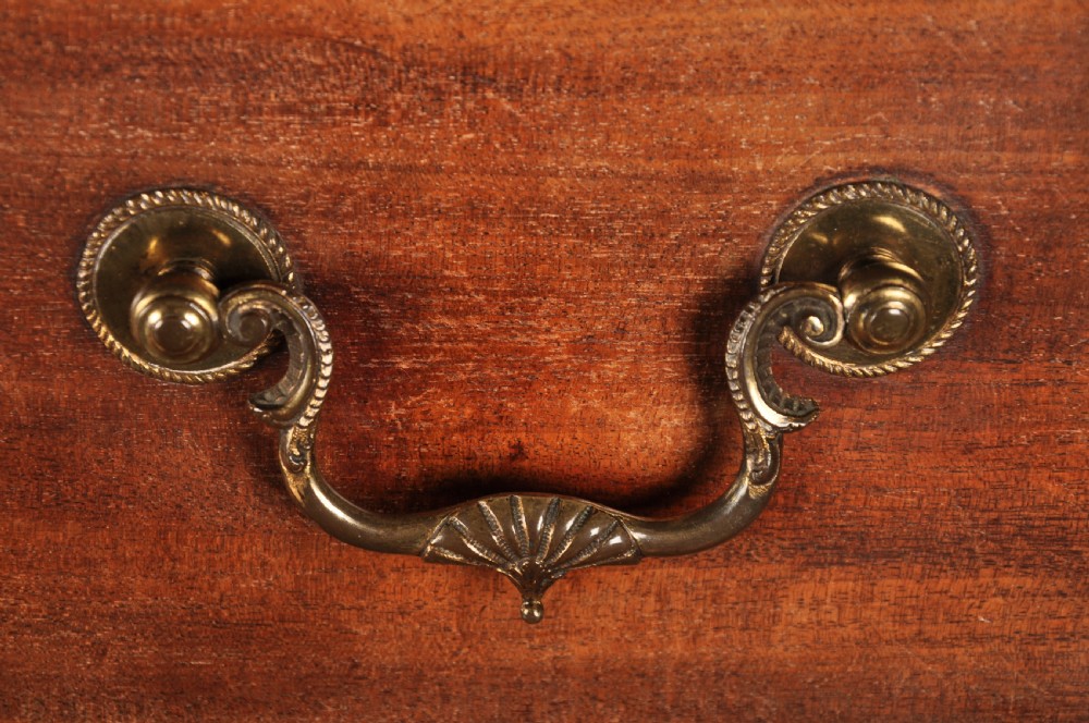 An 18th-century Georgian flame mahogany tallboy featuring a carved fretwork cornice, brass swan-neck handles, and ogee bracket feet. View XIII