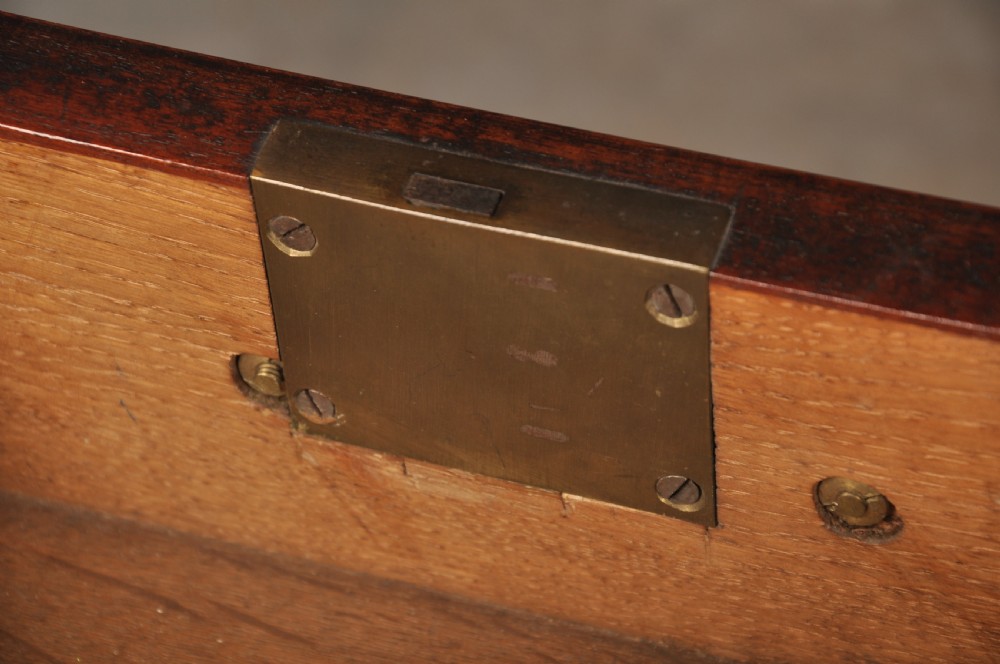 An 18th-century Georgian flame mahogany tallboy featuring a carved fretwork cornice, brass swan-neck handles, and ogee bracket feet. View XX