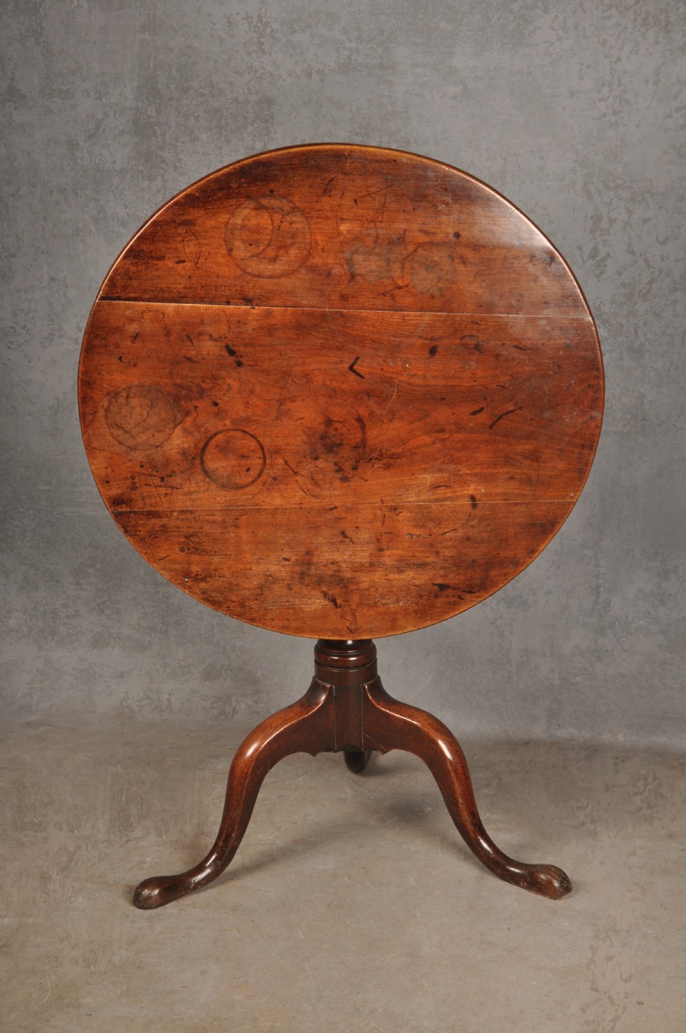 An 18th-century cherrywood tripod table featuring a circular top, turned baluster pedestal, and three splayed cabriole legs. View IV