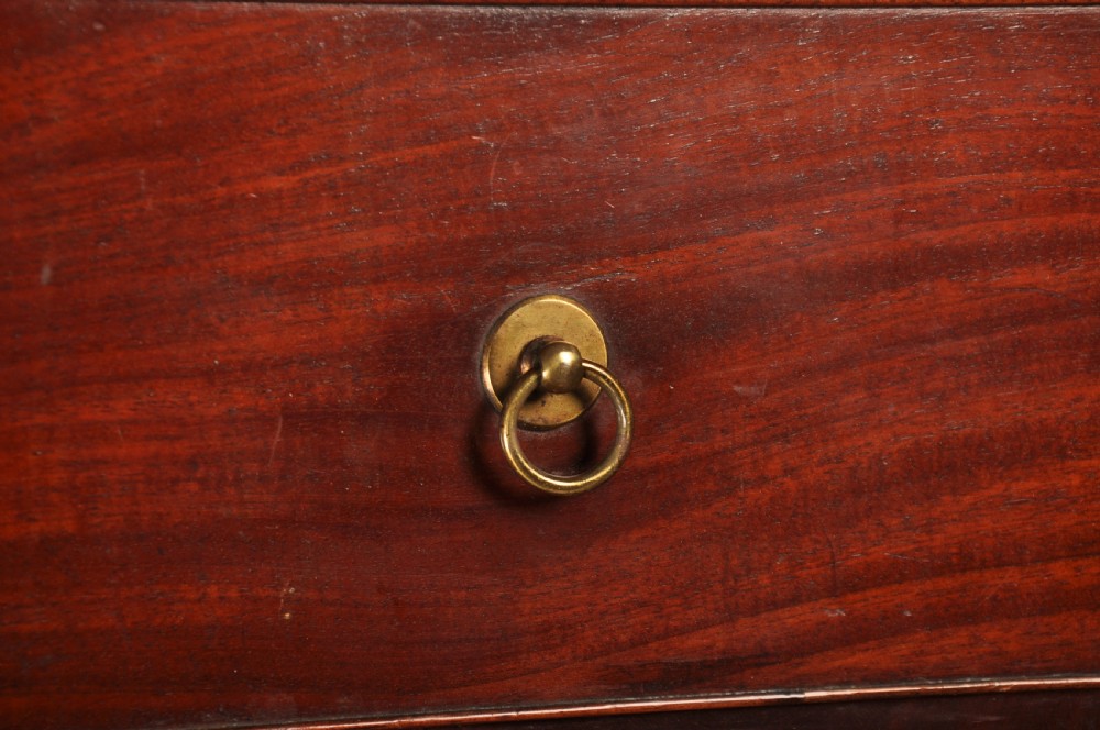 An 18th-century mahogany secretaire cabinet featuring twin upper doors with shaped gilded mouldings above an open fall-front desk with pigeonholes and three drawers on bracket feet. View IX