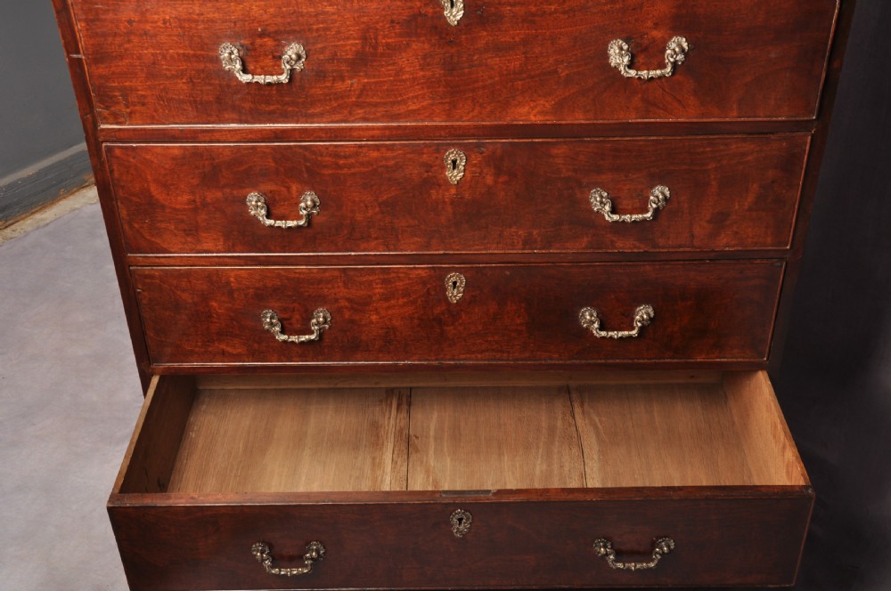 An 18th-century mahogany secretaire cabinet featuring twin upper doors with shaped gilded mouldings above an open fall-front desk with pigeonholes and three drawers on bracket feet. View XIII