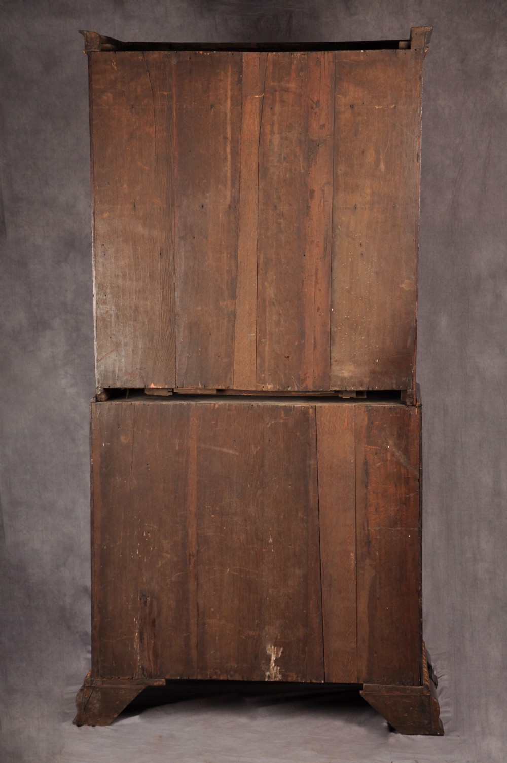An 18th-century mahogany secretaire cabinet featuring twin upper doors with shaped gilded mouldings above an open fall-front desk with pigeonholes and three drawers on bracket feet. View XIX