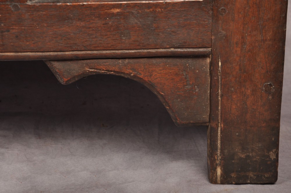 A Tudor era dark oak coffer featuring four carved linenfold panels and an iron lockplate on the front facade. View VIII